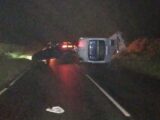 Crashed car and flipped over caravan