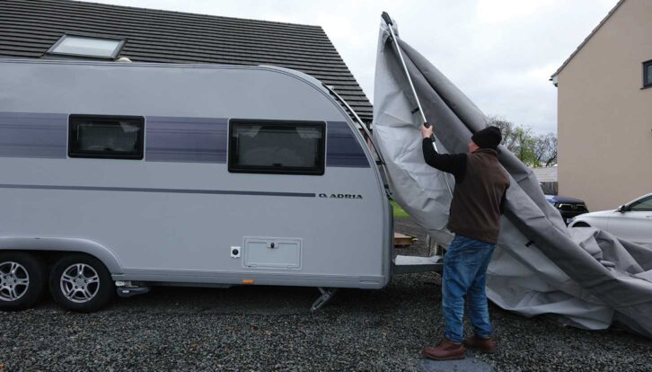 Lifting the cover over the van