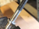 The jockey wheel clamp bolt after being polished