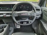 The steering wheel and infotainment screen in the cabin