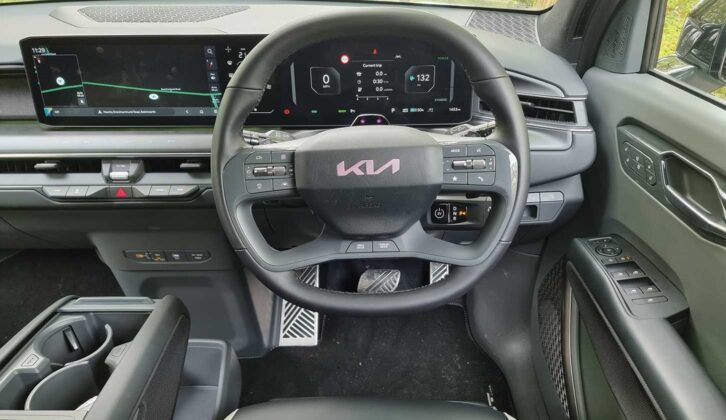 The steering wheel and infotainment screen in the cabin