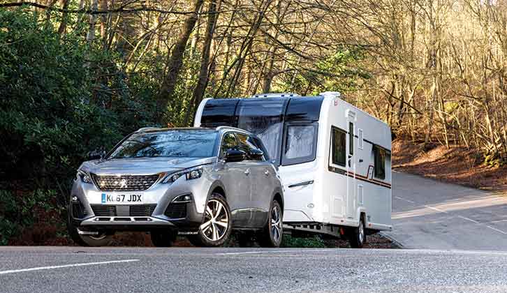 A Peugeot 5008 towing a caravan