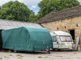 A covered caravan and a tourer without a cover