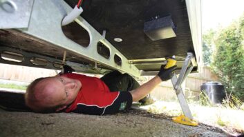 Carrying out a servicing underneath the caravan