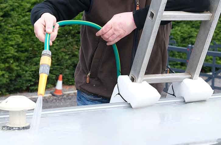 Rinsing the roof down with a hose