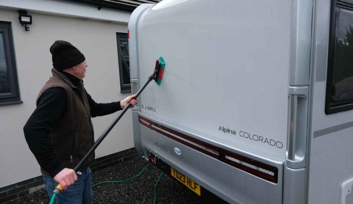 Using the brush to wash dirt off of the side of the tourer