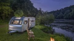 Adria's 2025 Alpina pitched up alongside a river