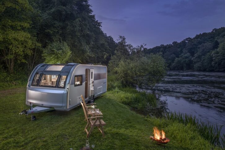 Adria's 2025 Alpina pitched up alongside a river