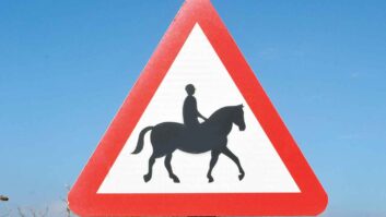 A road sign depicting a horse and rider