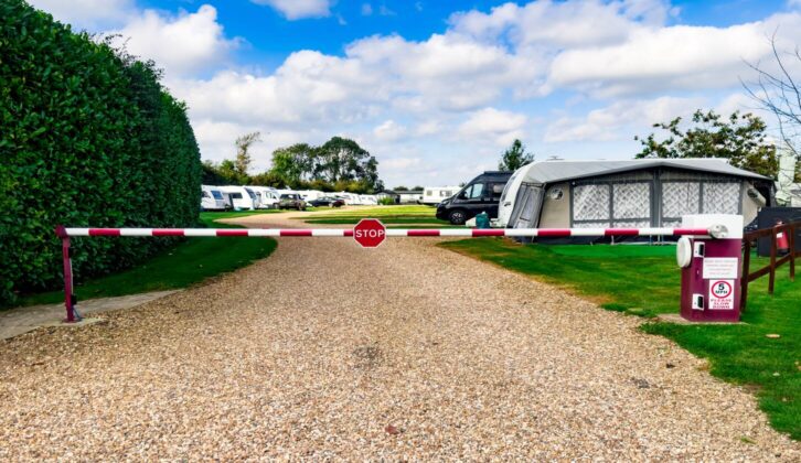 A campsite with caravans and motorhomes on a sunny day