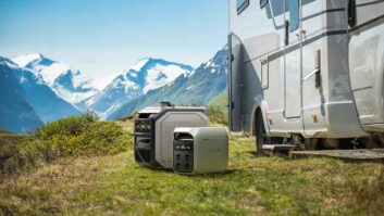 The EcoFlow Delta 3 Plus by a caravan with mountains in the background