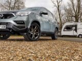 A Ssangyong Rexton parked by a caravan on an autumnal day