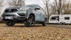 A Ssangyong Rexton parked by a caravan on an autumnal day