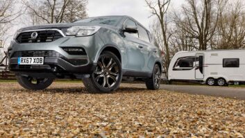 A Ssangyong Rexton parked by a caravan on an autumnal day